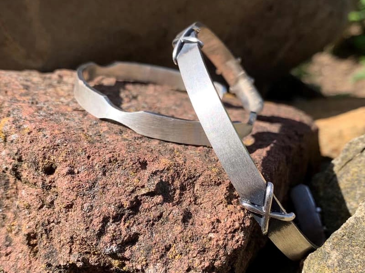 Minimal silver bracelet photographed on stone