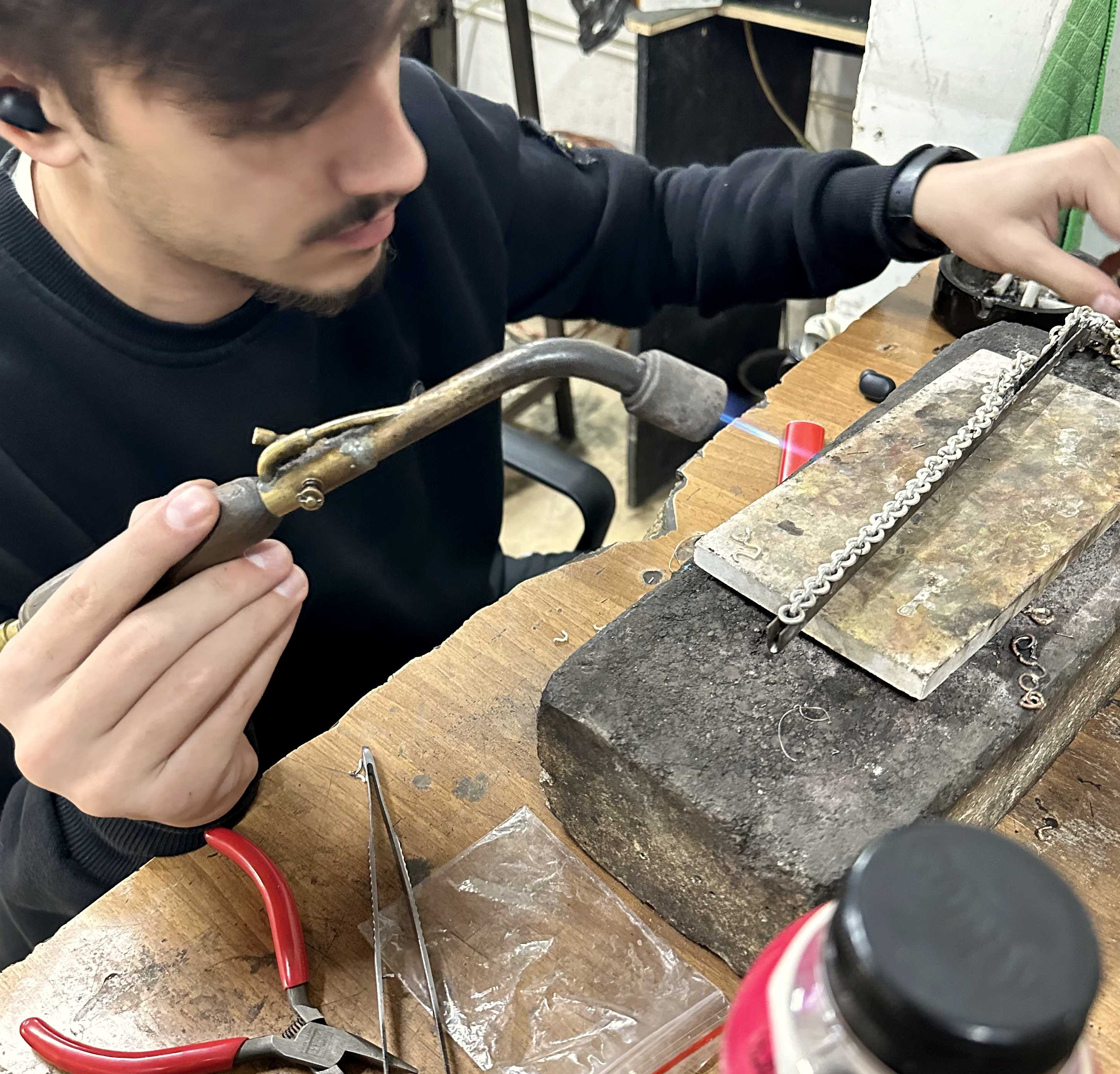 Jeweler working on chain at the bench