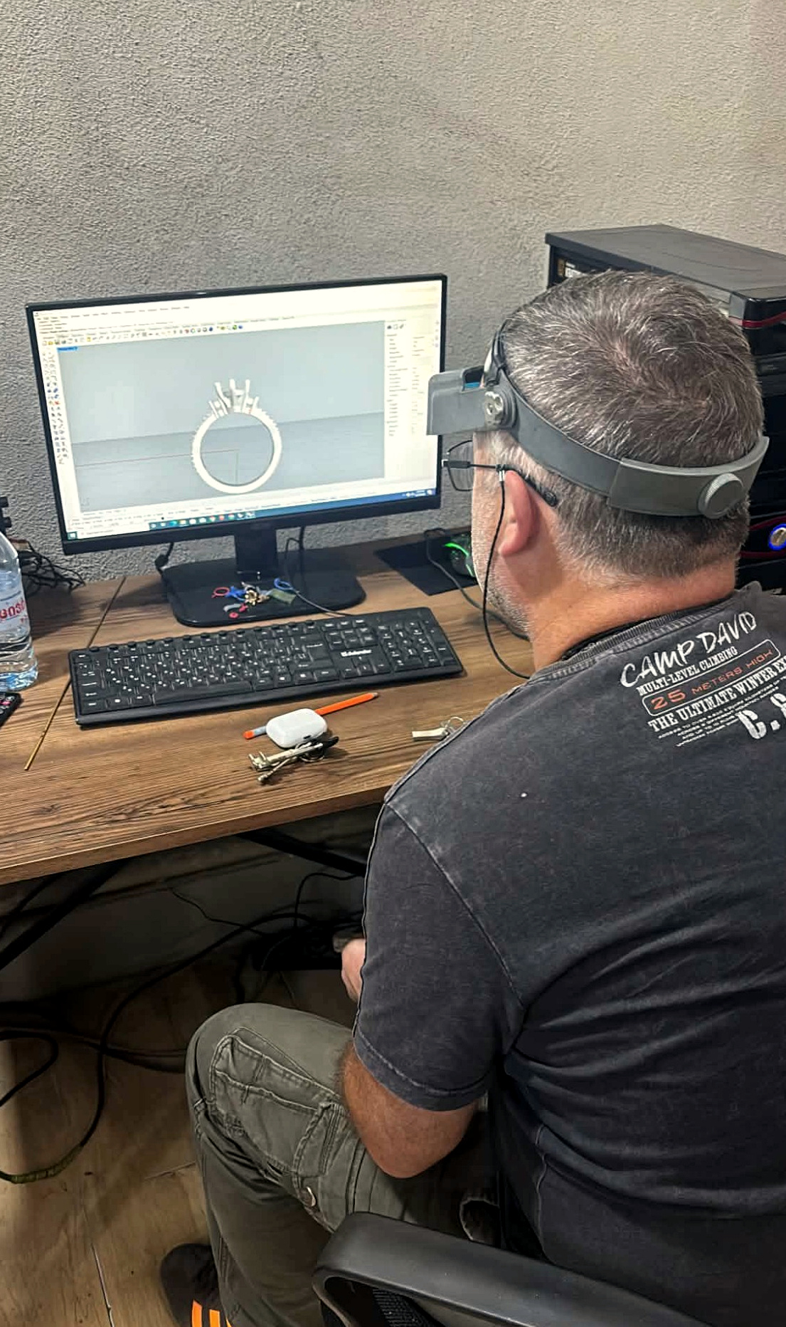 Lead jeweler reviewing a ring model in CAD