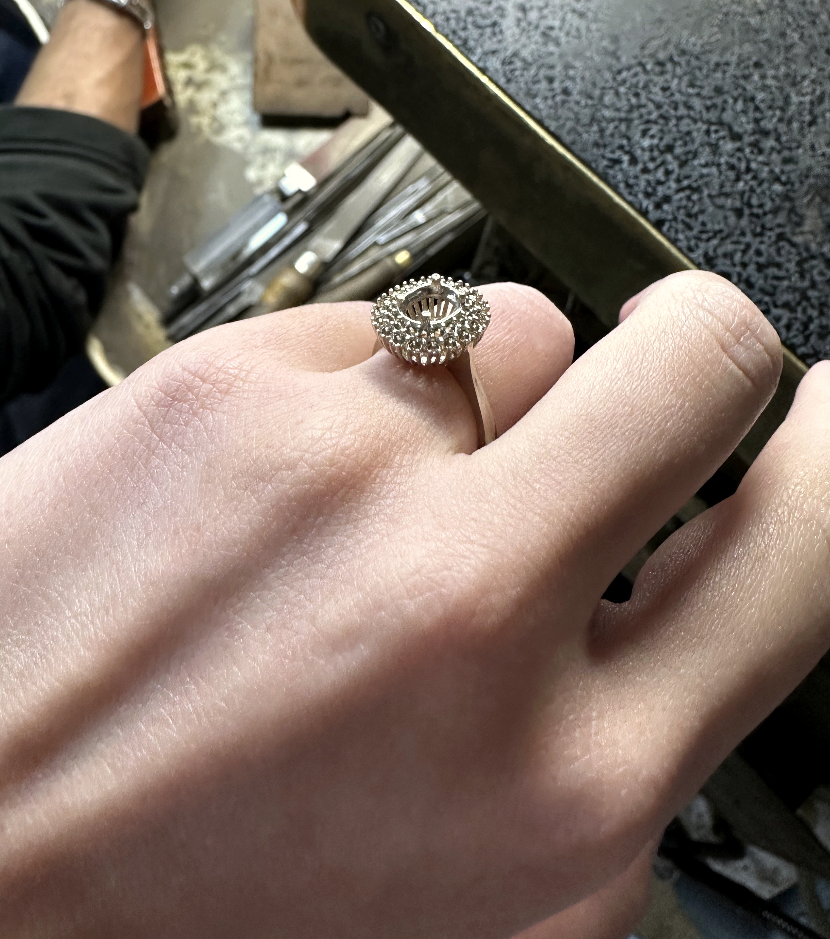 Ring setting being reviewed by hand